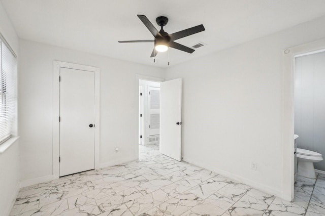 unfurnished bedroom featuring connected bathroom and ceiling fan