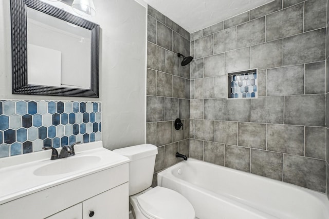 full bathroom featuring vanity, toilet, and tiled shower / bath combo