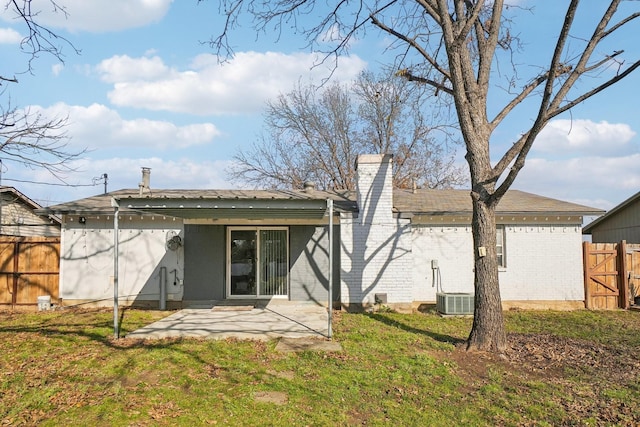 rear view of house with a lawn and a patio area