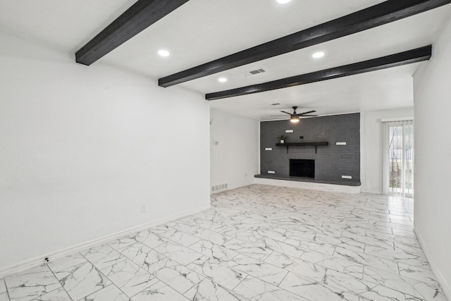 unfurnished living room with ceiling fan, a fireplace, and beam ceiling