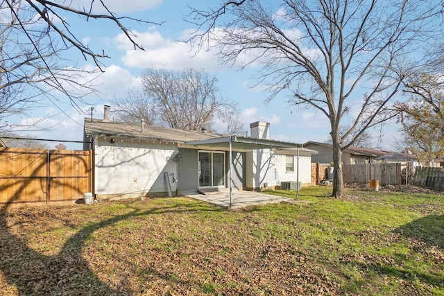 rear view of property featuring central AC, a yard, and a patio