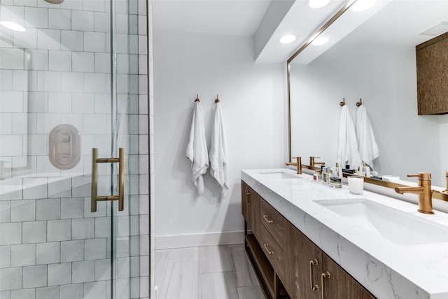 bathroom featuring tiled shower and vanity