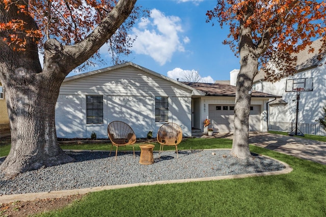 single story home with a front yard and a garage