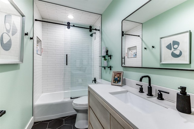 full bathroom featuring tile patterned floors, vanity, toilet, and enclosed tub / shower combo