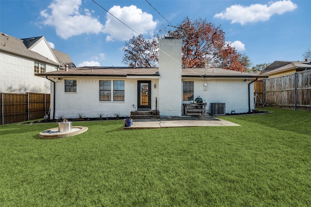 back of property with central AC, a yard, and a patio