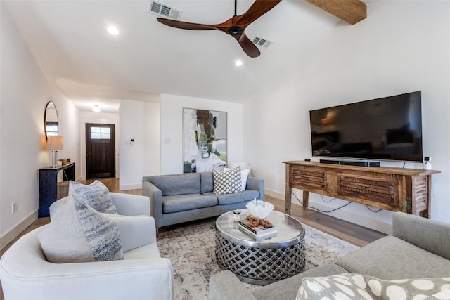 living room with hardwood / wood-style flooring, ceiling fan, and lofted ceiling