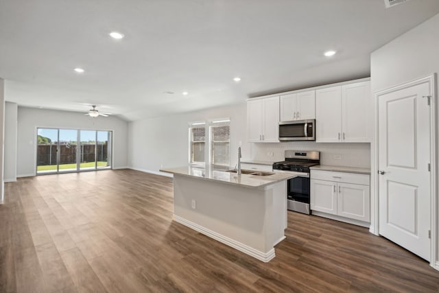 kitchen with sink, white cabinets, dark wood-type flooring, and appliances with stainless steel finishes