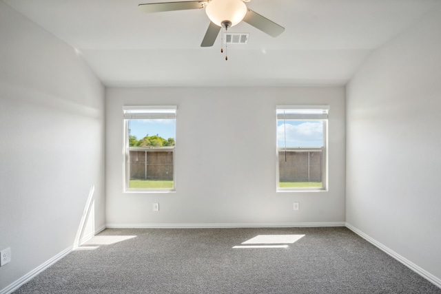 empty room featuring carpet floors, a healthy amount of sunlight, and lofted ceiling