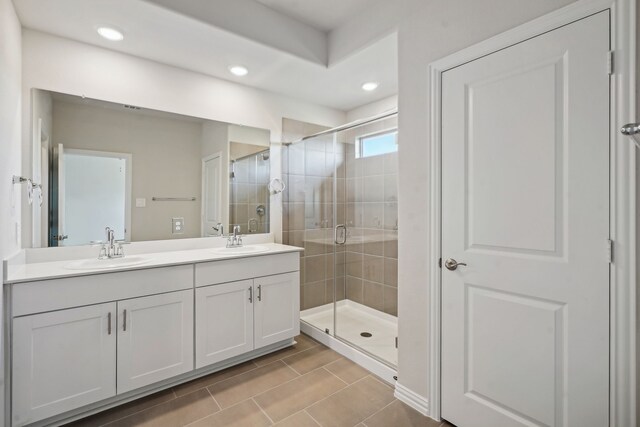 bathroom featuring vanity and an enclosed shower