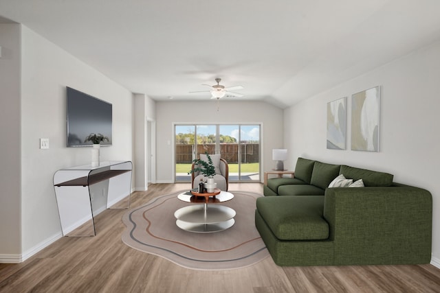 living room with hardwood / wood-style floors, ceiling fan, and lofted ceiling