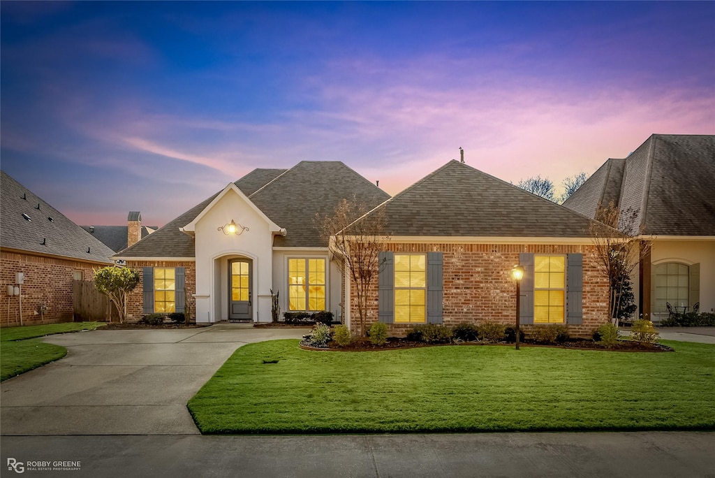 view of front of home with a lawn