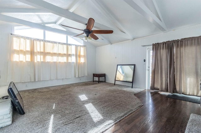 empty room featuring ceiling fan, lofted ceiling with beams, and dark hardwood / wood-style floors