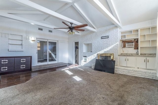 unfurnished living room with beamed ceiling, ceiling fan, dark carpet, and high vaulted ceiling