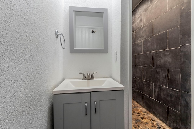 bathroom with a shower and vanity