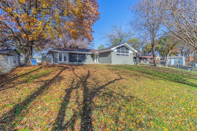 rear view of property featuring a yard