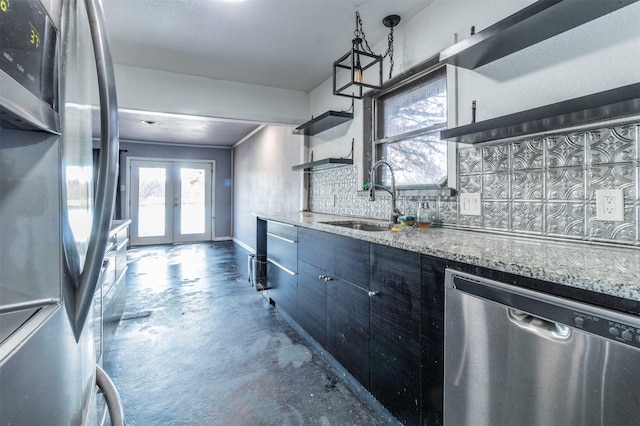 kitchen with french doors, sink, tasteful backsplash, light stone counters, and stainless steel appliances