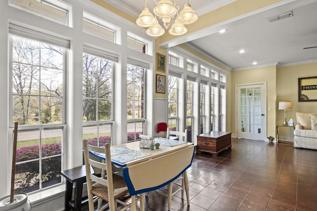 sunroom / solarium featuring an inviting chandelier