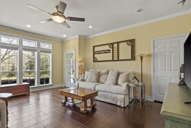 living room featuring dark tile patterned floors, crown molding, and ceiling fan