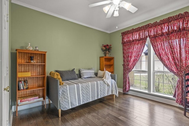 bedroom featuring ceiling fan, ornamental molding, and dark hardwood / wood-style flooring