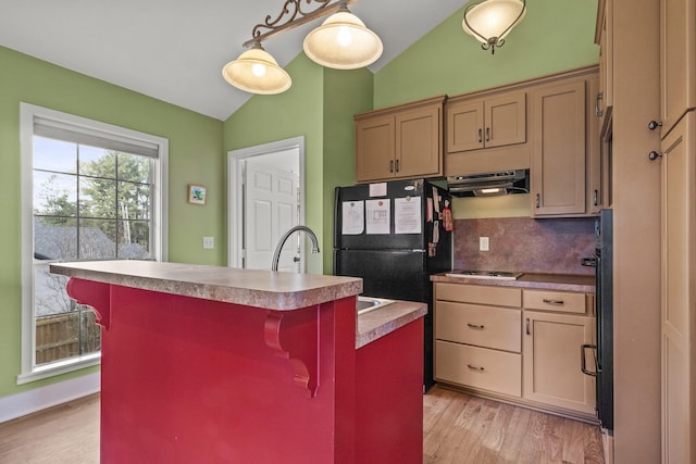 kitchen featuring a kitchen bar, backsplash, a kitchen island with sink, exhaust hood, and lofted ceiling