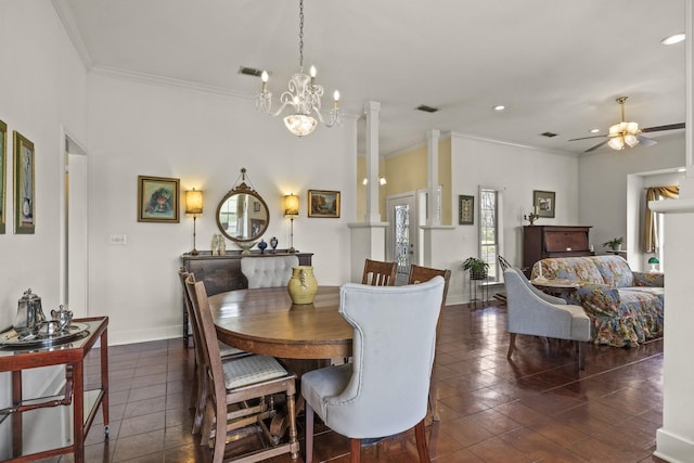 dining area with ceiling fan with notable chandelier, dark tile patterned flooring, and ornamental molding