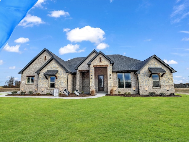 french country style house with a front lawn