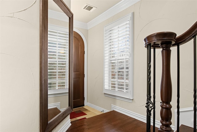 foyer entrance featuring crown molding