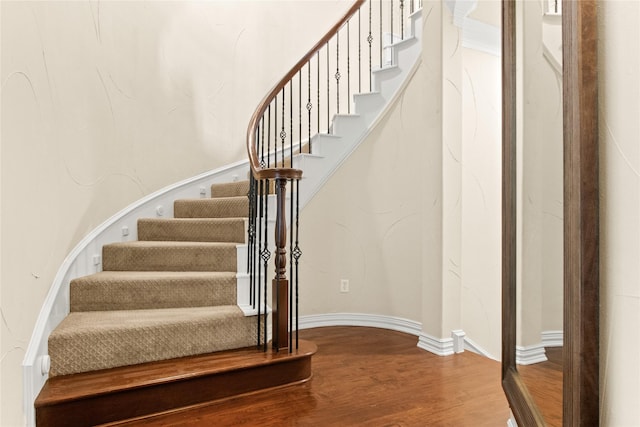 staircase with wood-type flooring