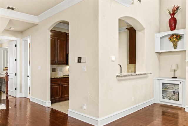 interior space featuring hardwood / wood-style flooring and ornamental molding