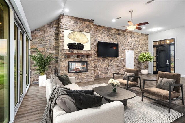 living room featuring ceiling fan, a fireplace, lofted ceiling, and hardwood / wood-style flooring