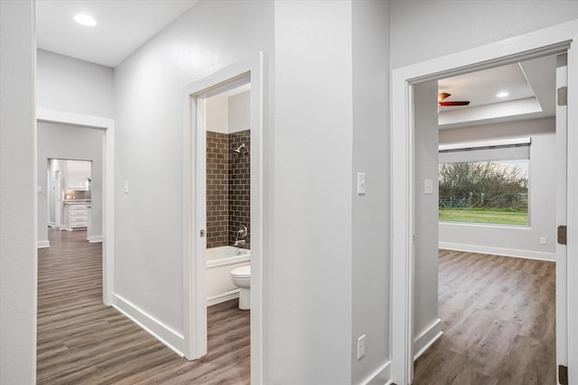 hall with recessed lighting, baseboards, and wood finished floors