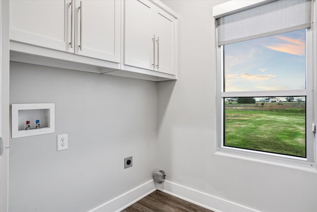 washroom featuring dark wood-type flooring, washer hookup, baseboards, cabinet space, and electric dryer hookup