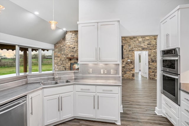 kitchen with white cabinetry, stainless steel appliances, and a sink