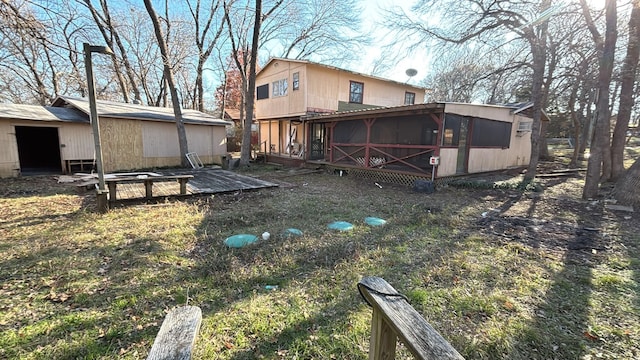 rear view of property featuring a wooden deck and a sunroom