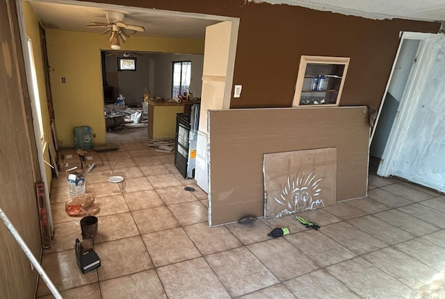 interior space with ceiling fan and light tile patterned floors