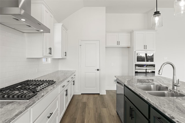 kitchen featuring sink, white cabinets, and wall chimney range hood