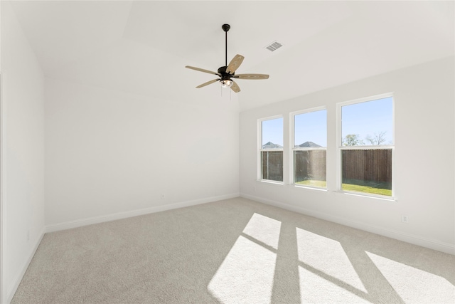 spare room featuring light carpet and ceiling fan