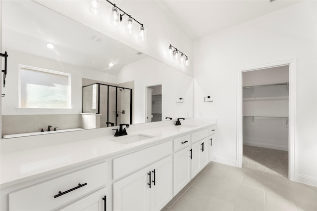 bathroom featuring vanity, tile patterned floors, and walk in shower