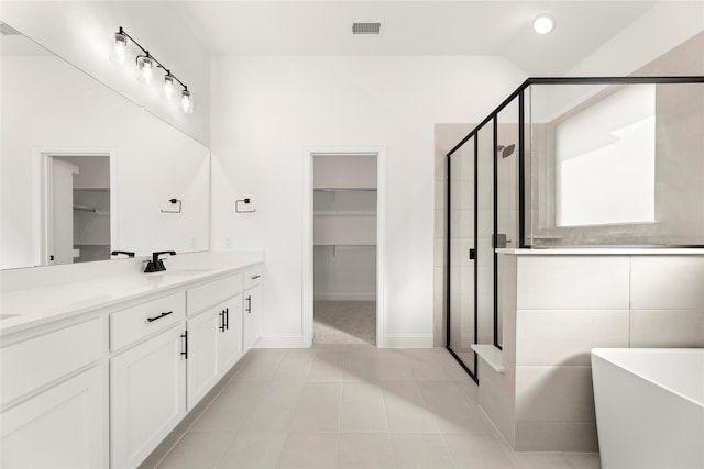 bathroom featuring tile patterned flooring, vanity, and independent shower and bath