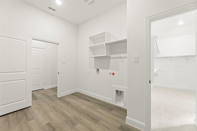 laundry area with hookup for a gas dryer, light hardwood / wood-style floors, washer hookup, and hookup for an electric dryer