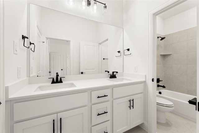 full bathroom featuring vanity, tiled shower / bath combo, and toilet