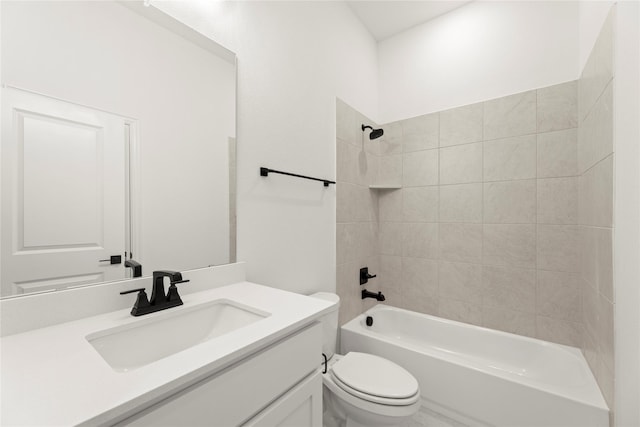 full bathroom with tiled shower / bath combo, toilet, and vanity