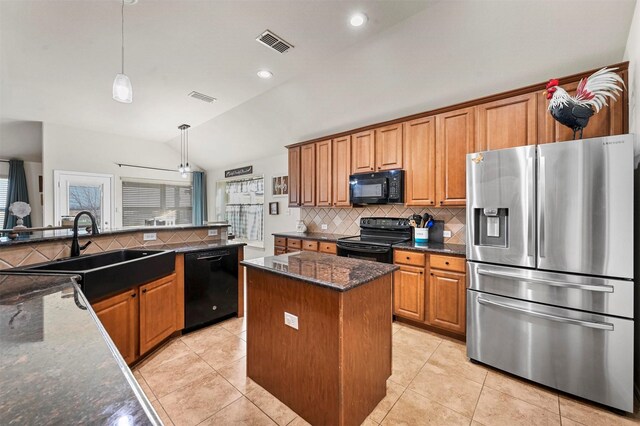 kitchen featuring sink, light tile patterned floors, black appliances, a kitchen island, and kitchen peninsula