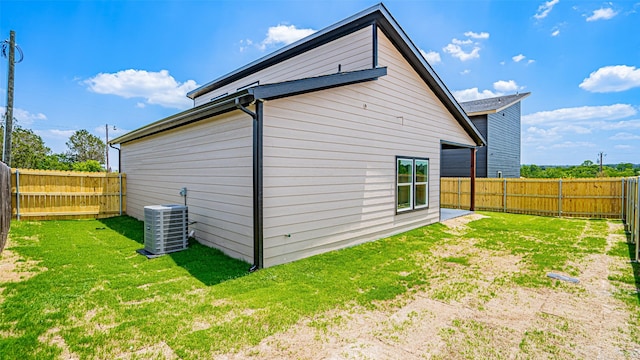 view of property exterior featuring central AC and a yard