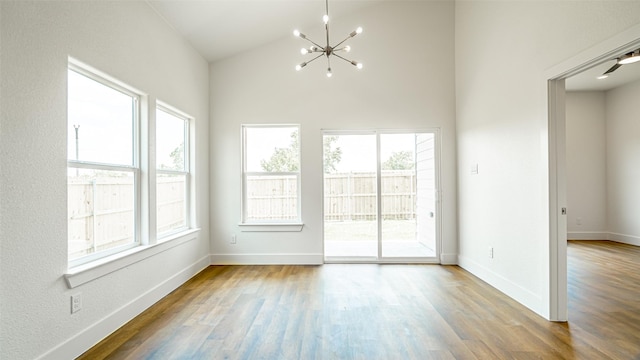 spare room with hardwood / wood-style floors and plenty of natural light