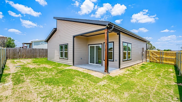 back of property featuring a yard and a patio