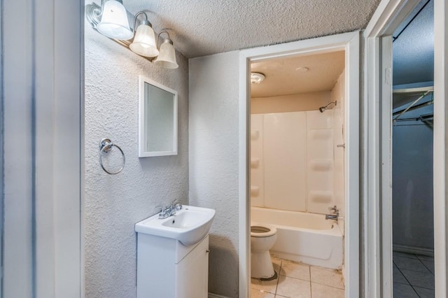 full bathroom featuring tile patterned floors, a textured ceiling, toilet, shower / tub combination, and vanity