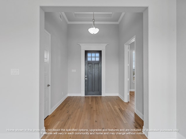 entryway with baseboards, ornamental molding, wood-type flooring, and visible vents