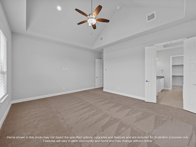 unfurnished bedroom with visible vents, carpet, baseboards, and high vaulted ceiling