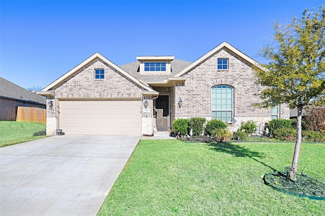 view of front of house with a garage and a front lawn